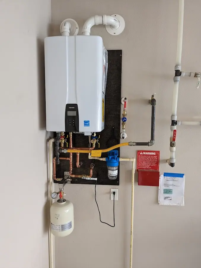 Professional plumber installing copper piping in a Hauula home